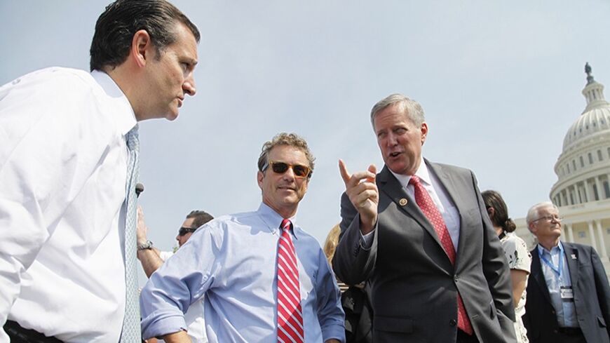 (L-R) U.S. Senator Ted Cruz (R-TX), Senator Rand Paul (R-KY) and Representative Mark Meadows (R-NC) chat as they arrive to speak at the Tea Party Patriots 'Exempt America from Obamacare' rally on the west lawn of the U.S. Capitol in Washington, September 10, 2013. REUTERS/Jonathan Ernst   (UNITED STATES - Tags: POLITICS HEALTH CIVIL UNREST) - RTX13G43