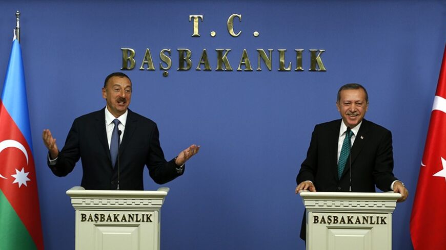 Azerbaijan's President Ilham Aliyev (L) and Turkey's Prime Minister Tayyip Erdogan address the media in Ankara November 13, 2013. Erdogan said on Wednesday work on the Trans-Anatolian natural gas pipeline project (TANAP), which will carry Azeri natural gas, will begin in early 2014. Turkey, which has a 20 percent stake in TANAP, and Azerbaijan, which controls 80 percent, are looking at ways to cooperate on shipping Azeri gas to the Balkans, Erdogan also said after talks with Azeri President Ilham Aliyev in 