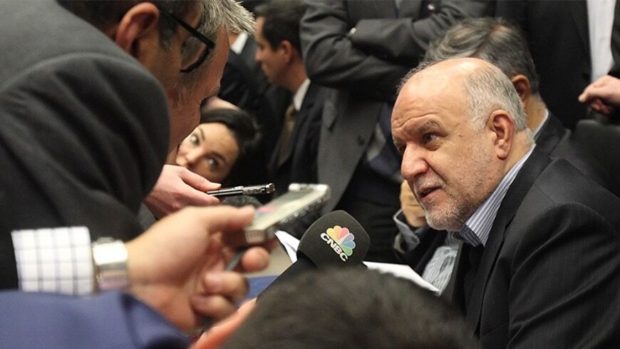 Iranian Oil Minister Bijan Zanganeh talks to journalists before a meeting of OPEC oil ministers at OPEC's headquarters in Vienna December 4, 2013. Zanganeh said on Wednesday he expected Iranian oil output to reach 4 million barrels per day at the end of next year. REUTERS/Heinz-Peter Bader  (AUSTRIA - Tags: POLITICS ENERGY) - RTX1635R