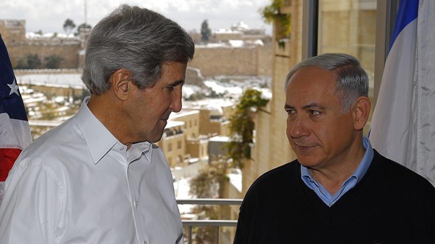 U.S. Secretary of State John Kerry (L) talks to Israeli Prime Minister Benjamin Netanyahu from a room overlooking the snow covered city of Jerusalem, during a meeting December 13, 2013.  REUTERS/Brian Snyder (JERUSALEM - Tags: POLITICS) - RTX16GGI
