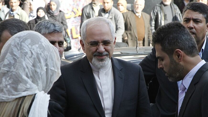 Iran's Foreign Minister Mohammad Javad Zarif (C) arrives at the Syrian parliament building for talks with Syrian officials in Damascus January 15, 2014.  REUTERS/Khaled al-Hariri (SYRIA - Tags: POLITICS CONFLICT) - RTX17F2K