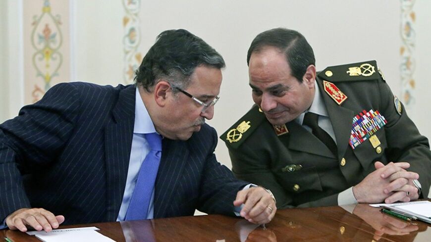 Egypt's Foreign Minister Nabil Fahmy (L) speaks with Army chief Field Marshal Abdel Fattah al-Sisi (R) during their meeting with Russian President Vladimir Putin at the Novo-Ogaryovo state residence outside Moscow, February 13, 2014. REUTERS/Maxim Shemetov (RUSSIA - Tags: POLITICS MILITARY) - RTX18QBK