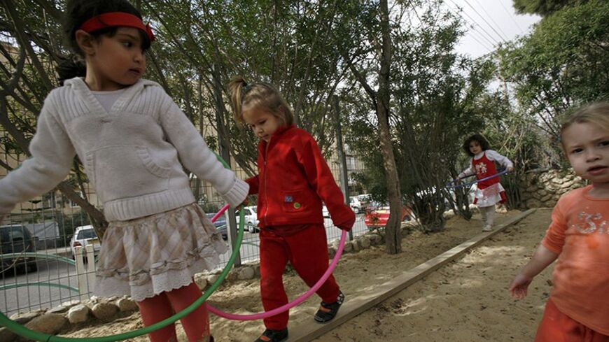 Children play at the Hagar pre-school and kindergarten in the southern Israeli city of Beersheba January 29, 2009. The school, which was closed for three weeks during the fighting in Gaza, is located within the range of rockets fired by Palestinian militants in Gaza. Beersheba was the target of several rocket strikes during the conflict. But this school is attempting to bridge some of the cultural chasms which split the region. 25 of the school's pupils are Jewish and 25 are Arab. Picture taken January 29, 