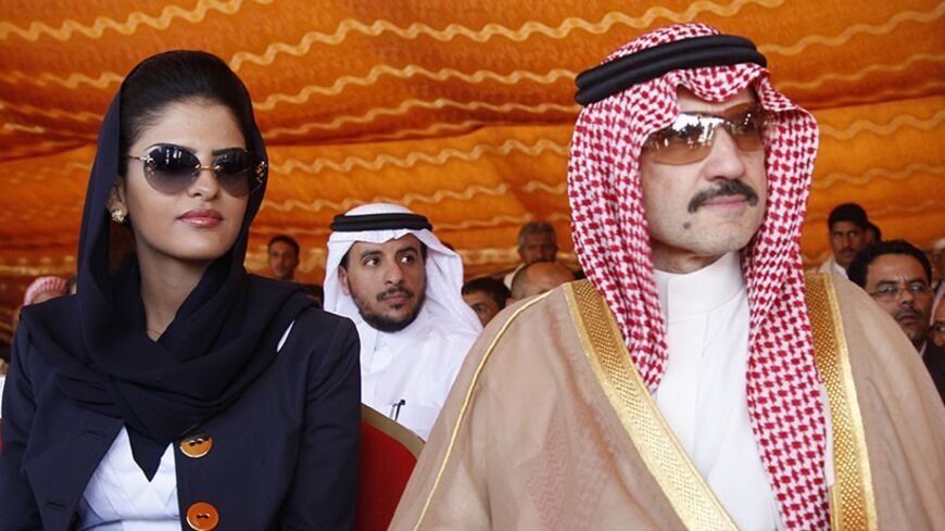 Saudi Prince al-Waleed bin Talal (R) and his wife Princess Amira al-Taweel attend a ceremony for the opening of housing units in the al-Dhafir village, west of Sanaa May 24, 2009. The houses were built by al-Waleed for victims of the December 28, 2005 landslide in al-Dhafir. The landslide killed 65 people and destroyed 27 of the village's 31 houses. REUTERS/Khaled Abdullah (YEMEN POLITICS ROYALS SOCIETY) - RTXMPSM