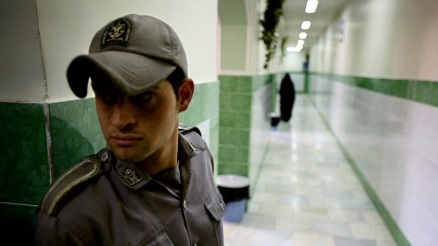 A prison guard stands along a corridor in Tehran's Evin prison June 13, 2006. Iranian police detained 70 people at a demonstration in favour of women's rights, the judiciary said on Tuesday, adding it was ready to review reports that the police had beaten some demonstrators. - RTXOQWJ