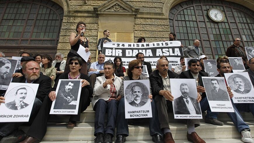 Human rights activists hold pictures of Armenian victims in front of the historical Haydarpasa station in Istanbul April 24, 2010, during a demonstration to commemorate the 1915 mass killing of Armenians in the Ottoman Empire. Muslim Turkey accepts many Christian Armenians died in partisan fighting beginning in 1915 but denies that up to 1.5 million were killed and that it amounted to genocide, a term used by some Western historians and foreign parliaments. Banner reads "Never again".  REUTERS/ Osman Orsal 