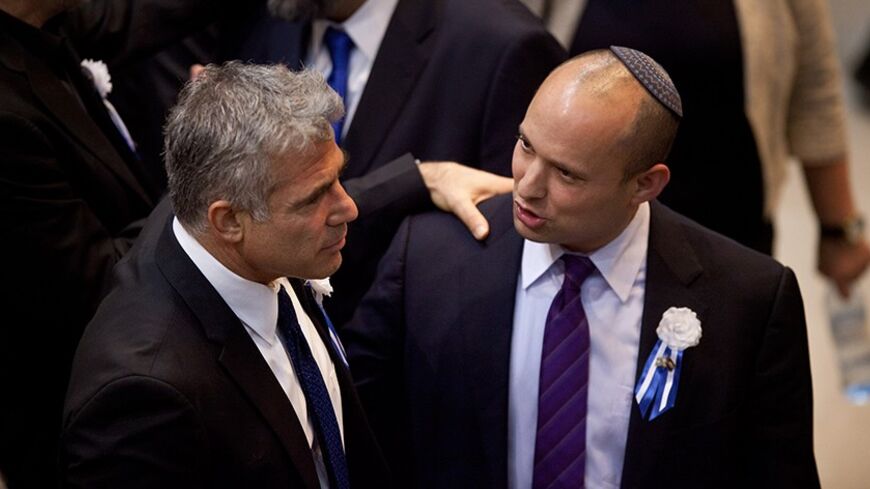 JERUSALEM, ISRAEL - FEBRUARY 05: Yair Lapid leader of the Israeli Yesh Atid party (L) and Naftali Bennett, head of Israel's Jewish Home party attend the swearing-in ceremony of the 19th Knesset, the new Israeli parliament, on February 5, 2013 in Jerusalem, Israel.  The 120 members included a record 48 new law makers.  (Photo by Uriel Sinai/Getty Images)