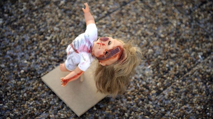 A picture taken on May 23, 2013 shows a beat-up and bruised doll diplayed during an exhibition that aims at raising public awareness of child abuse at Tel Avivs Rabin Square, Israel.  AFP PHOTO/DAVID BUIMOVITCH        (Photo credit should read DAVID BUIMOVITCH/AFP/Getty Images)