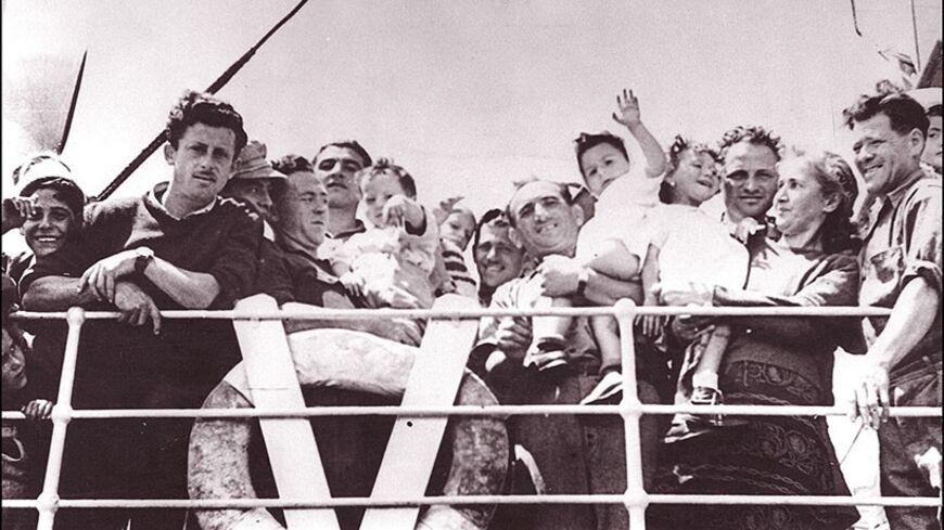 TEL-AVIV, ISRAEL:  The crowd of Jewish immigrants waving from the deck of trawler "Andria" as they arrive 20 May 1948 at Tel Aviv harbor. Israel was founded on 14 May 1948 by the Jewish National Council and was recognized by the United States and the Soviet Union 15 and 17 May. (Photo credit should read AFP/Getty Images)