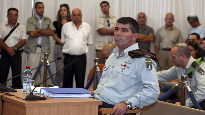 Israel's army chief Lieutenant-General Gabi Ashkenazi (front) sits before testifying at a state-appointed inquiry into the Israeli naval raid on a Gaza aid flotilla, in Jerusalem, August 11, 2010. Ashkenazi acknowledged on Wednesday that his troops were not ready for the violent resistance encountered when they boarded the Gaza-bound aid ship and ended up killing nine pro-Palestinian activists. REUTERS/Gali Tibbon/Pool (JERUSALEM - Tags: POLITICS CIVIL UNREST MILITARY) - RTR2H8JL