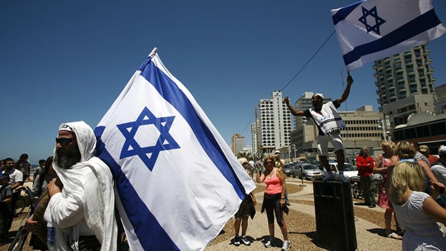An ultra Orthodox Jewish man dances with a flag during celebrations for Israel's 63nd Independence Day celebrations in Tel Aviv May 10, 2011. REUTERS/Baz Ratner (ISRAEL - Tags: ANNIVERSARY MILITARY) - RTR2M7S6
