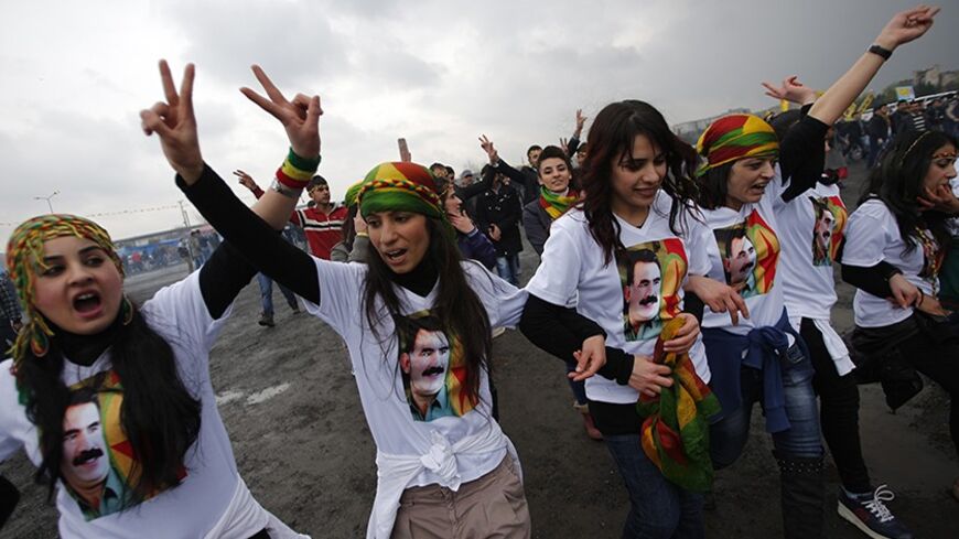 Demonstrators wearing t-shirts with a picture of imprisoned PKK leader Abdullah Ocalan, gesture during a rally to celebrate the spring festival of Newroz in Istanbul March 17, 2013. REUTERS/Murad Sezer (TURKEY - Tags: POLITICS CIVIL UNREST) - RTR3F4B3