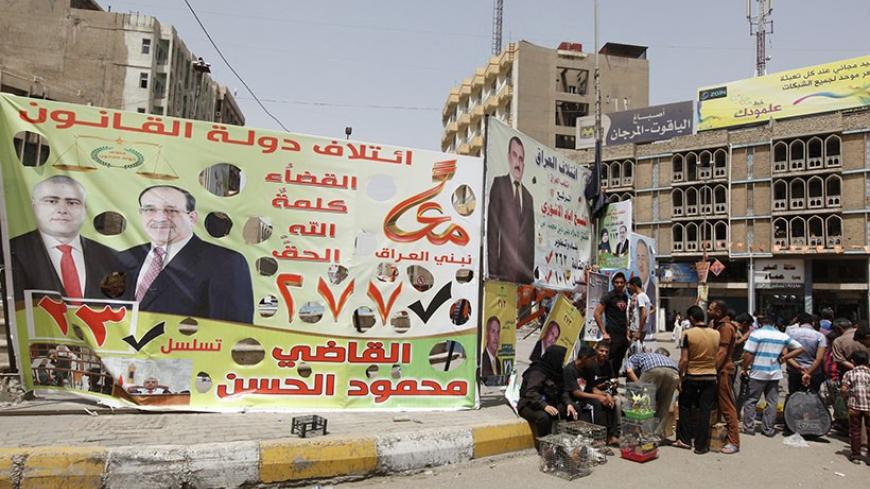 An election poster of Mahmoud Al-Hassan of Prime Minister Nuri al-Maliki's State of Law coalition is displayed along a street at the start of the election campaign in Baghdad April 18, 2014. Iraq is holding its national election at the end of this month.  REUTERS/Ahmed Saad (IRAQ - Tags: POLITICS ELECTIONS) - RTR3LSZ3