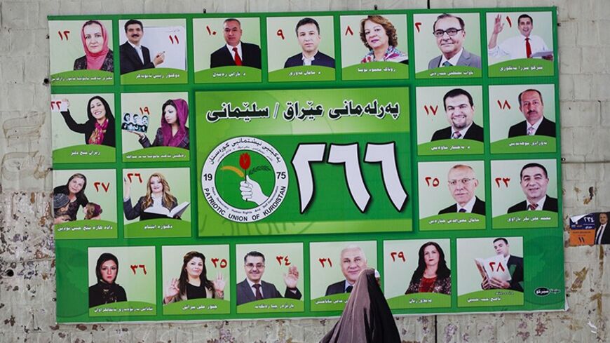 A woman walks past a Patriotic Union of Kurdistan (PUK) campaign poster for Iraq's parliamentary elections in Sulaimaniya April 28, 2014. Picture taken April 28, 2014.        To match IRAQ-ELECTION/KURDS         REUTERS/Jacob Russell (IRAQ - Tags: POLITICS ELECTIONS TPX IMAGES OF THE DAY) - RTR3N0GU