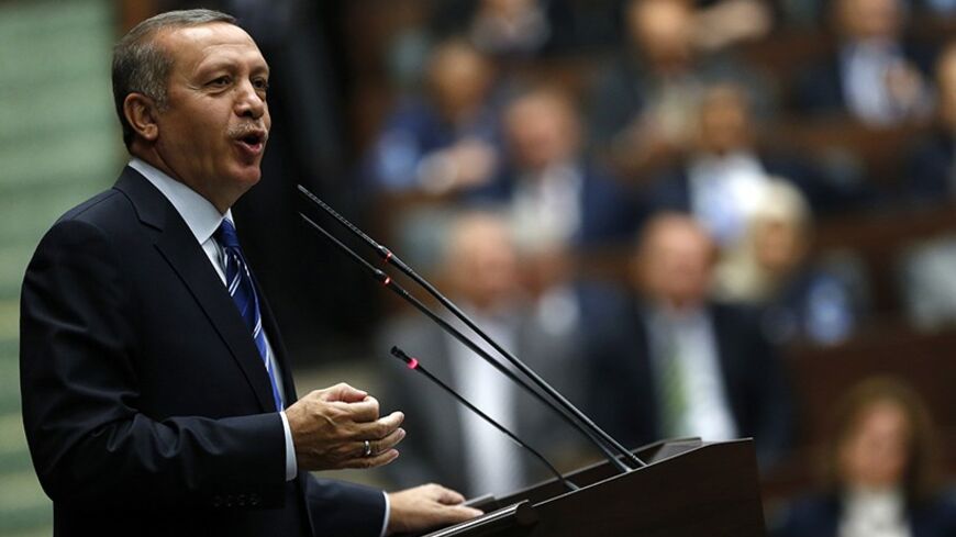 Turkey's Prime Minister Tayyip Erdogan addresses members of parliament from his ruling AK Party (AKP) during a meeting at the Turkish parliament in Ankara April 29, 2014. REUTERS/Umit Bektas (TURKEY - Tags: POLITICS) - RTR3N1Z0