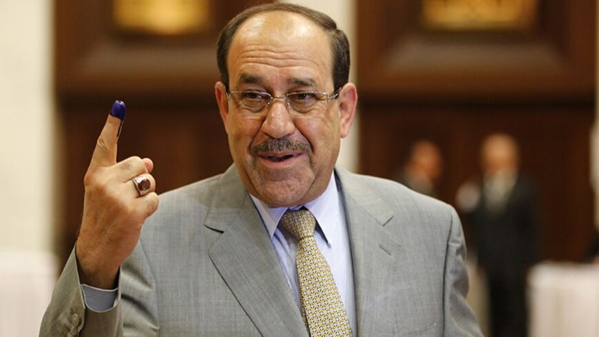 Iraq's Prime Minister Nuri al-Maliki shows his ink marked finger as he votes during parliamentary election in Baghdad April 30, 2014. Iraqis head to the polls on Wednesday in their first national election since U.S. forces withdrew from Iraq in 2011 as Prime Minister Nuri Maliki seeks a third term amid rising violence.
 REUTERS/Ahmed Jadallah  (IRAQ - Tags: ELECTIONS POLITICS TPX IMAGES OF THE DAY) - RTR3N6JL