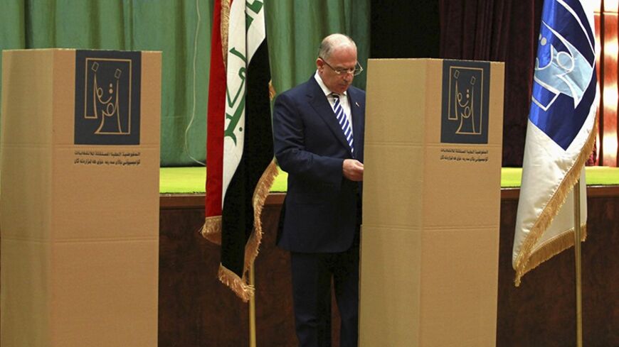 Osama al-Nujaifi, speaker of the Iraqi Council of Representatives, casts his vote at a polling station during a parliamentary election in Baghdad April 30, 2014. Iraqis headed to the polls on Wednesday in their first national election since U.S. forces withdrew from Iraq in 2011, with Prime Minister Nuri al-Maliki seeking a third term amid rising violence. REUTERS/Mahmoud Raouf Mahmoud (IRAQ - Tags: ELECTIONS POLITICS) - RTR3N8XT