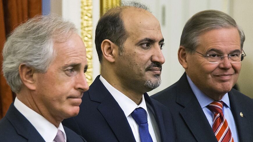 Senator Bob Corker (R-TN) (L) and Senator Robert Menendez (D-NJ) (R) of the Senate Foreign Relations Committee hold a meeting with Syrian National Coalition president Ahmad Jarba (C) at the U.S. Capitol in Washington May 7, 2014. U.S. President Barack Obama is expected to meet Jarba during his visit to Washington over the next week, a White House official said on Tuesday. Jarba, who is in Washington through May 14, will meet with U.S. Secretary of State John Kerry on Thursday. REUTERS/Jonathan Ernst (UNITED