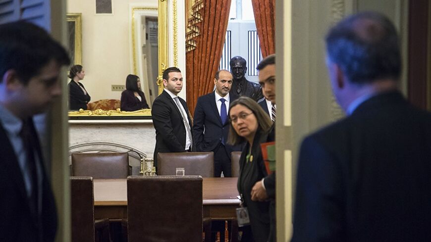 Syrian National Coalition president Ahmad Jarba (center right, in blue tie) waits to meet with U.S. Senator Robert Menendez (D-NJ) (not pictured) and members of the Senate Foreign Relations Committee, at the U.S. Capitol in Washington May 7, 2014. REUTERS/Jonathan Ernst (UNITED STATES - Tags: POLITICS) - RTR3O774