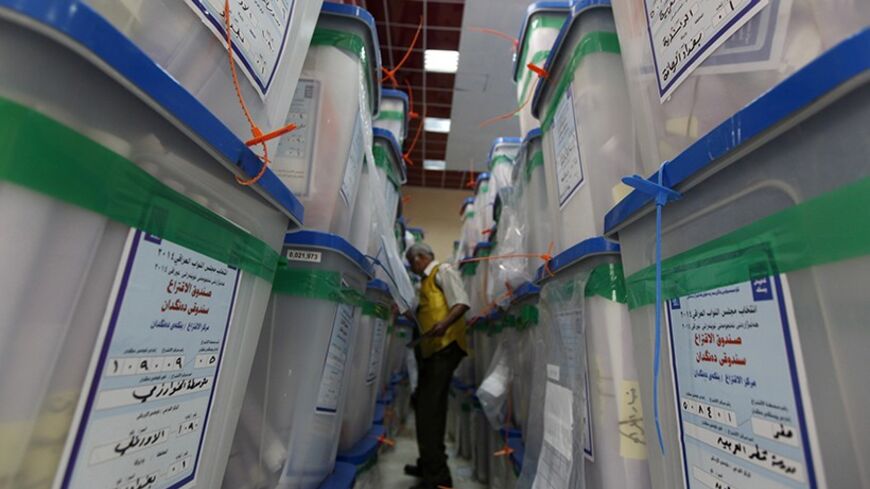 An employee of the Independent High Electoral Commission (IHEC) checks the numbers written on boxes containing the parliamentary elections ballots at an analysis centre in Baghdad May 9, 2014.   REUTERS/Ahmed Saad (IRAQ - Tags: ELECTIONS POLITICS) - RTR3OFS6