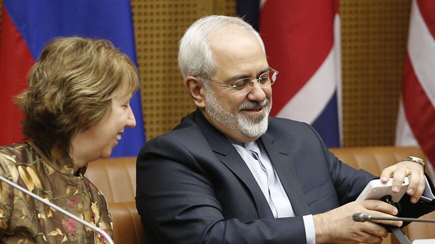 European Union foreign policy chief Catherine Ashton (L) and Iranian Foreign Minister Mohammad Javad Zarif wait for the start of talks in Vienna May 14, 2014. Six world powers and Iran launch the decisive phase of diplomacy over Tehran's nuclear work during three-day talks starting in Vienna on Wednesday, with the aim of resolving their decade-old dispute by July 20 despite skepticism a deal is possible. REUTERS/Leonhard Foeger  (AUSTRIA - Tags: POLITICS ENERGY) - RTR3P1ZA