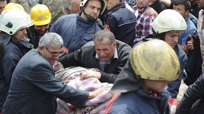 Rescuers carry a miner who sustained injuries after a mine explosion to an ambulance in Soma, a district in Turkey's western province of Manisa May 14, 2014. Hopes faded of finding more survivors in a coal mine in western Turkey on Wednesday, where 238 workers were confirmed killed and 120 more still feared to be trapped in what is likely to prove the nation's worst ever industrial disaster. REUTERS/Gokhan Gungor/Depo Photos (REUTERS - Tags: DISASTER ENERGY) ATTENTION EDITORS - FOR EDITORIAL USE ONLY. NOT F