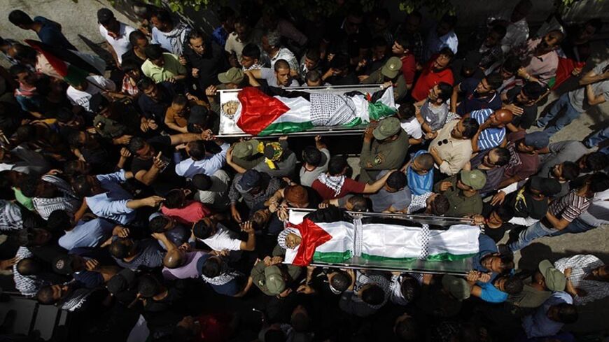 ATTENTION EDITORS - VISUAL COVERAGE OF SCENES OF INJURY OR DEATH

Mourners carry the bodies of two Palestinians, who were shot dead by Israeli forces on Thursday, during their funeral in the West Bank city of Ramallah May 16, 2014. Israeli forces shot dead the two Palestinians during a stone-throwing protest on Thursday to mark the "Nakba", or "catastrophe", as Palestinians term their displacement when Israel was founded. REUTERS/Mohamad Torokman (WEST BANK - Tags: POLITICS) TEMPLATE OUT - RTR3PGKE