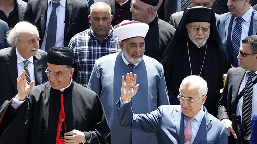 Lebanese President Michel Sleiman (R) gestures beside Maronite Patriarch Beshara al-Rai (L),  in a celebration to solidify the reconciliation between Christians and Druze in Brih May 17, 2014. REUTERS/Mohamed Azakir  (LEBANON - Tags: POLITICS RELIGION) - RTR3PLSX