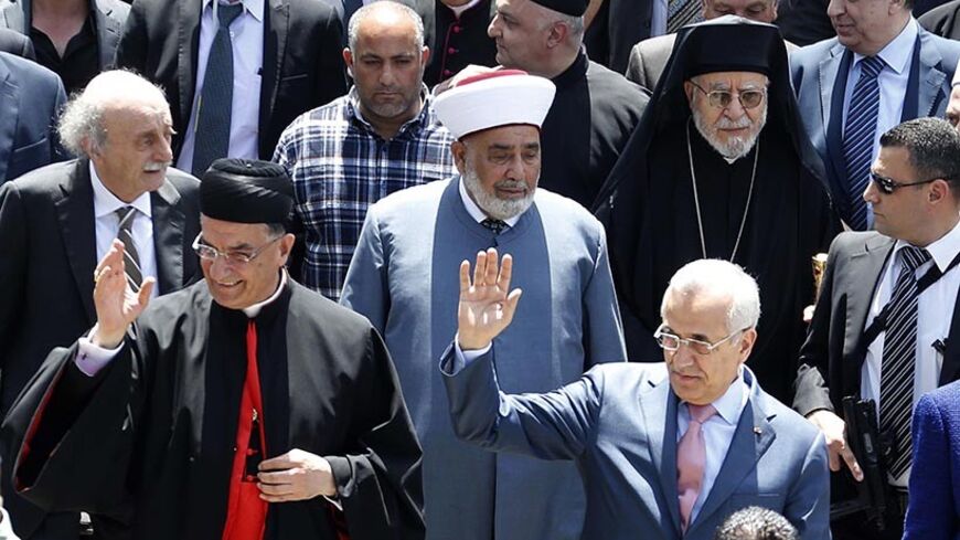 Lebanese President Michel Sleiman (R) gestures beside Maronite Patriarch Beshara al-Rai (L),  in a celebration to solidify the reconciliation between Christians and Druze in Brih May 17, 2014. REUTERS/Mohamed Azakir  (LEBANON - Tags: POLITICS RELIGION) - RTR3PLSX