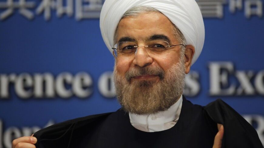 Iran's President Hassan Rouhani smiles as he leaves a news conference at a hotel after the fourth Conference on Interaction and Confidence Building Measures in Asia (CICA) summit, in Shanghai May 22, 2014. Rouhani said on Thursday he is not pessimistic about reaching an agreement over nuclear talks with the United States, Russia, China, France, Britain and Germany. REUTERS/Carlos Barria (CHINA - Tags: POLITICS) - RTR3QAZK