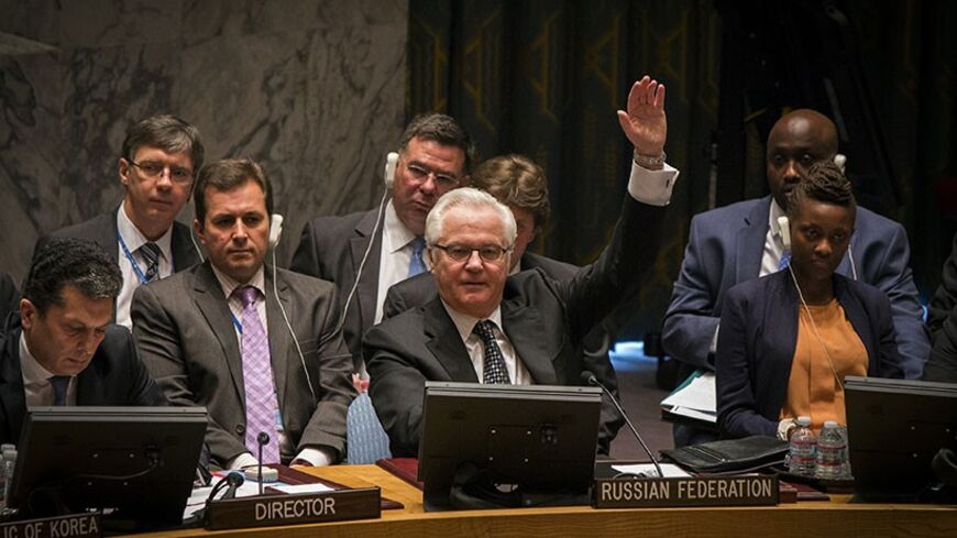 Russia's UN Ambassador Vitaly Churkin votes in the United Nations Security Council against referring the Syrian crisis to the International Criminal Court for investigation of possible war crimes at the U.N. headquarters in New York May 22, 2014. REUTERS/Lucas Jackson (UNITED STATES - Tags: POLITICS) - RTR3QE4L