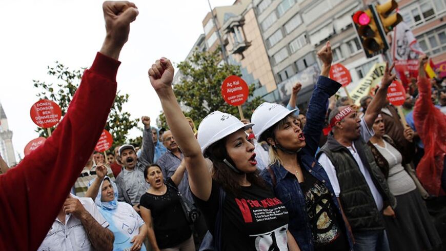Alevi demonstrators shout anti-goverment slogans during a protests against the latest violence in Okmeydani, a working-class district in the center of the city, in Istanbul May 25, 2014. Two people died last week after clashes between Turkish police and protesters in Okmeydani, a working-class district of Istanbul, stirring fears of further unrest as the anniversary of last year's anti-government demonstrations approaches. Okmeydani is home to a community of Alevis, a religious minority in mainly Sunni Musl