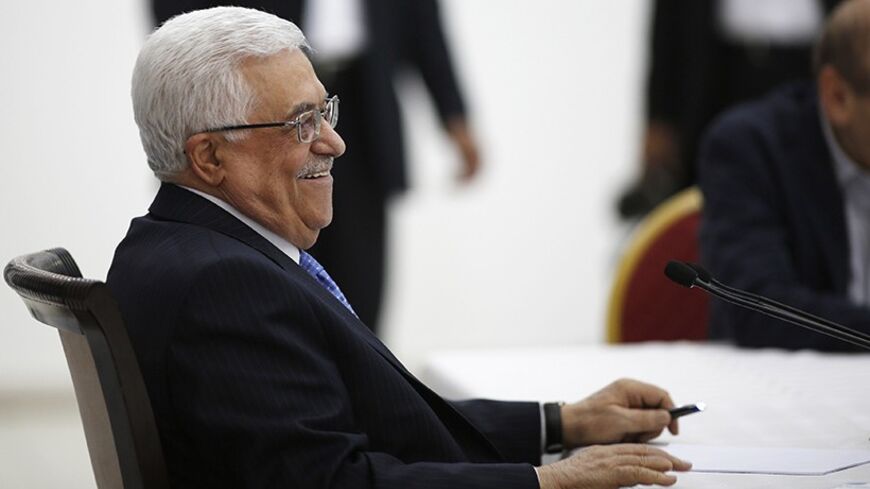 Palestinian President Mahmoud Abbas smiles during a meeting of the Palestinian leadership in the West Bank city of Ramallah July 18, 2013. As Palestinian leaders discussed a possible U.S-brokered resumption of peace talks on Thursday, the Israeli government denied a shift in its conditions that might help end a three-year stalemate. Abbas began briefing fellow PLO leaders in Ramallah on his meetings this week with U.S. Secretary of State John Kerry, who has extended his stay in the region and appears to be 