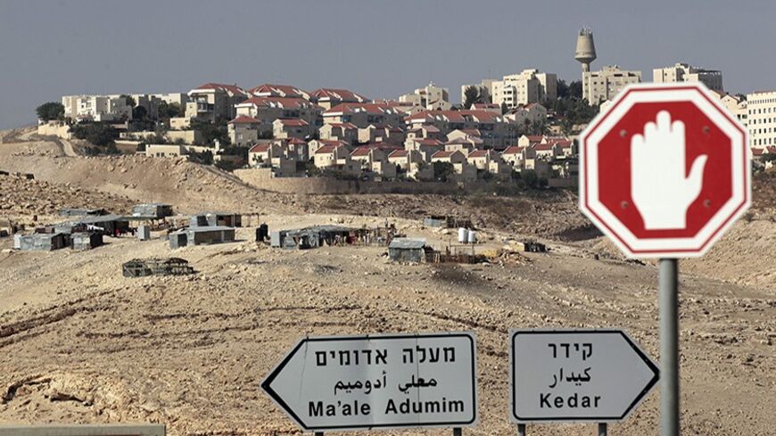 Sign posts are seen in front of the West Bank Jewish settlement of Maale Adumim near Jerusalem November 13, 2013. Palestinian President Mahmoud Abbas said on Wednesday his peace negotiators had resigned over the lack of progress in U.S.-brokered statehood talks clouded by Israeli settlement building. REUTERS/Ammar Awad (WEST BANK - Tags: POLITICS) - RTX15BNL
