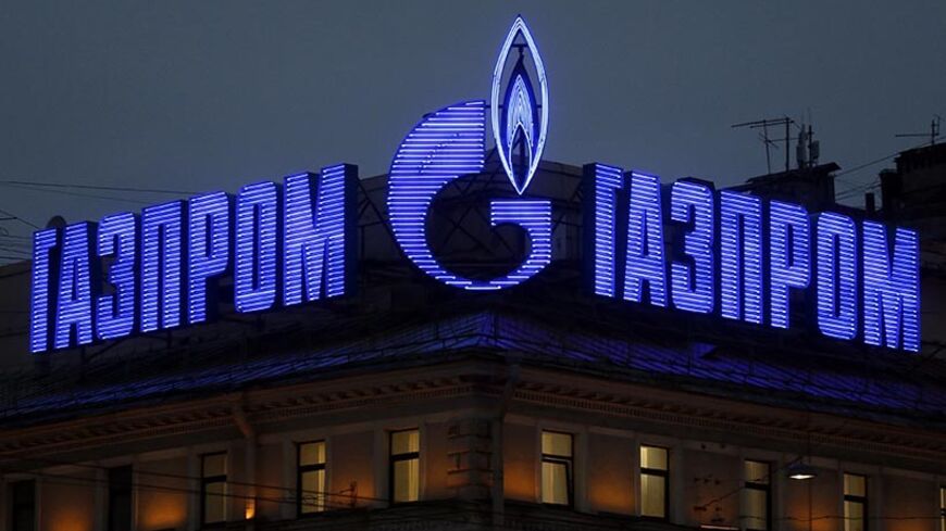 The company logo of Russian natural gas producer Gazprom is seen on an advertisement installed on the roof of a building in St. Petersburg, November 14, 2013. Repayments made by Russia's Gazprom to German utility RWE for gas purchases going back to 2010 helped drive earnings at RWE's trading unit 1.3 billion euros ($1.7 billion) higher in the first nine months of this year, RWE said on Thursday.  REUTERS/Alexander Demianchuk (RUSSIA - Tags: BUSINESS ENERGY) - RTX15DDT
