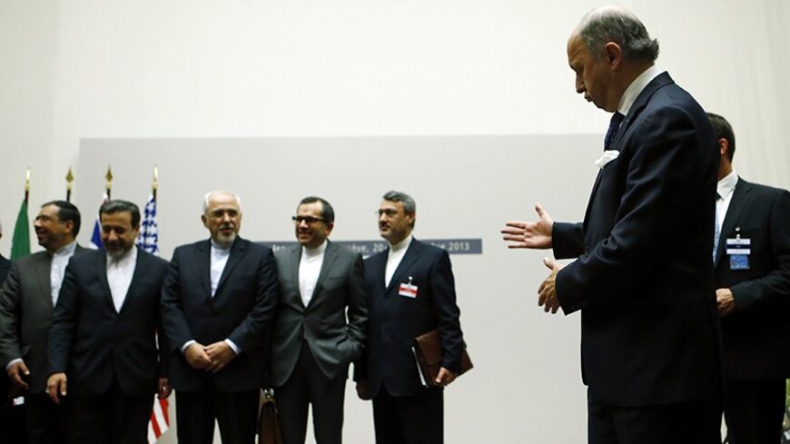 French Foreign Minister Laurent Fabius (R) gestures as Iranian Foreign Minister Mohammad Javad Zarif (3rd L) watches, after a ceremony at the United Nations in Geneva November 24, 2013.  Iran and six world powers reached a breakthrough agreement early on Sunday to curb Tehran's nuclear programme in exchange for limited sanctions relief, in a first step towards resolving a dangerous decade-old standoff. REUTERS/Denis Balibouse (SWITZERLAND - Tags: POLITICS) - RTX15QNG