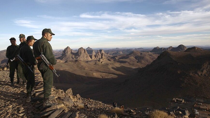 Algerian Gendarmes take position on top of the Askrem Mountain near Tamanrasset,  some 2,000 km (1,243 miles) south of the Algerian capital Algiers, December 13, 2013. Picture taken December 13, 2013.  REUTERS/Ramzi Boudina (ALGERIA - Tags: MILITARY ENVIRONMENT) - RTX16JAC