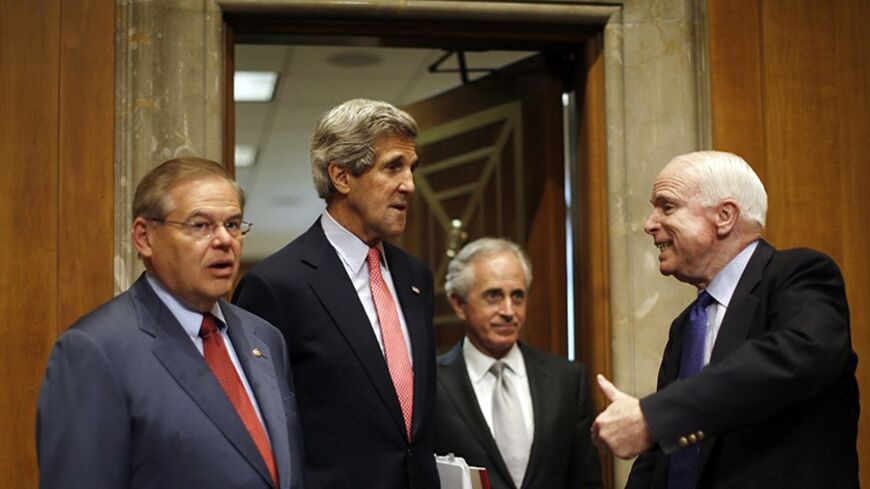 U.S. Secretary of State John Kerry (2nd L)  arrives to testify at a Senate Foreign Relations Committee hearing on national security and foreign policy priorities for the 2014 international affairs budget, on Capitol Hill in Washington, April 18, 2013. Kerry on Thursday asked senators pressing for tougher sanctions over Iran's nuclear ambitions to be patient, saying there is uncertainty in the Islamic republic two months before its June 14 election. Pictured with Kerry are (L-R) committee chairman Robert Men