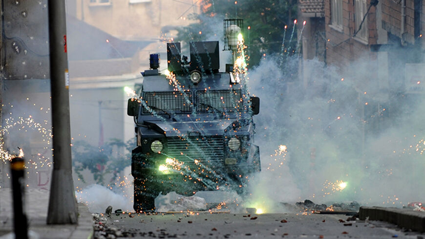 Fireworks thrown by Kurdish protestors burst in front of a riot police vehicle during a clashes with riot police on June 8, 2014 at Okmeydani district in Istanbul. The demonstration followed the death of a man during clashes with Turkish soldiers the night before in Lice, southeastern Turkey. Two Kurdish protesters have died of gunshot wounds sustained during fierce clashes with Turkish soldiers in the country's southeast on June 7. Three people, including two soldiers, were hospitalised after the demonstra