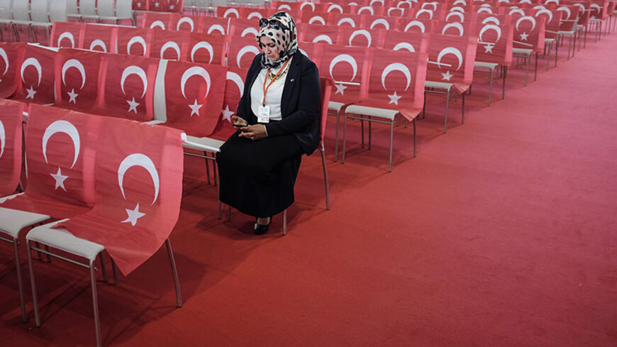 A woman wearing a head scarf checks her mobile device as she awaits the speech of the Turkish Prime Minister during an event to mark the 10th anniversary of the Union of European Turkish Democrats UETD at the Albert Schultz Hall in Vienna, Austria on June 19, 2014. Austria warned the Turkish Prime Minister on June 12, 2014 not to say anything that may "split" Austrian society during his visit.  
AFP PHOTO / PATRICK DOMINGO        (Photo credit should read Patrick Domingo/AFP/Getty Images)