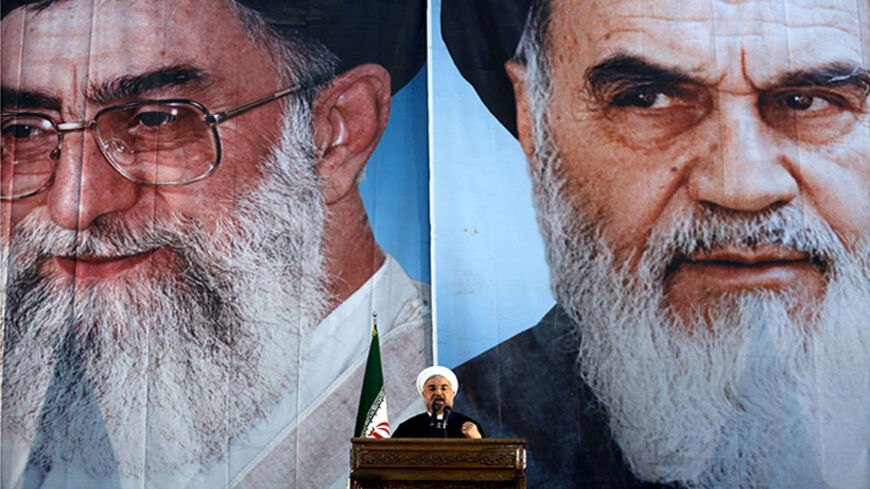 Iranian President Hassan Rouhani delivers a speech under portraits of Iran's supreme leader, Ayatollah Ali Khamenei (L) and Iran's founder of the Islamic Republic, Ayatollah Ruhollah Khomeini (R), on the eve of the 25th anniversary of the Islamic revolutionary leader Ayatollah Ruhollah Khomeini's death, at his mausoleum in a suburb of Tehran on June 3, 2014. AFP PHOTO / ATTA KENARE        (Photo credit should read ATTA KENARE/AFP/Getty Images)