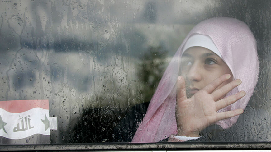 An Iraqi girl in sits in a car outside a shopping mall in Amman January 31, 2007. Violence in Iraq and instability in Lebanon are driving hundreds of thousands of people abroad in an upheaval not matched in the Middle East since the exodus of Palestinian refugees when Israel was created in 1948. To match feature MIGRATION-MIDEAST. REUTERS/Ali Jarekji    (JORDAN) - RTR1LU56