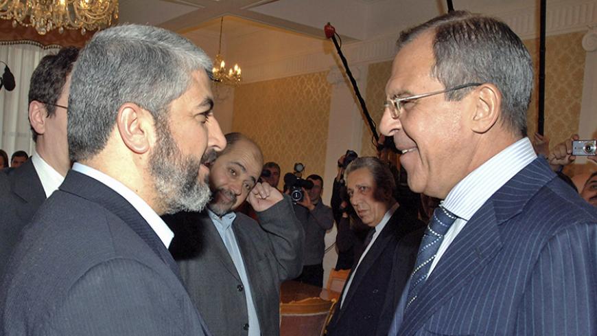 Hamas leader Khaled Meshaal (L) and Russia's Foreign Minister Sergei Lavrov shake hands as they meet in Moscow February 27, 2007. Meshaal praised Russia's efforts to end a Western aid embargo on the Palestinian administration during a visit to Moscow intended to win support for a new unity government.    REUTERS/Pool   (RUSSIA) - RTR1MVPV