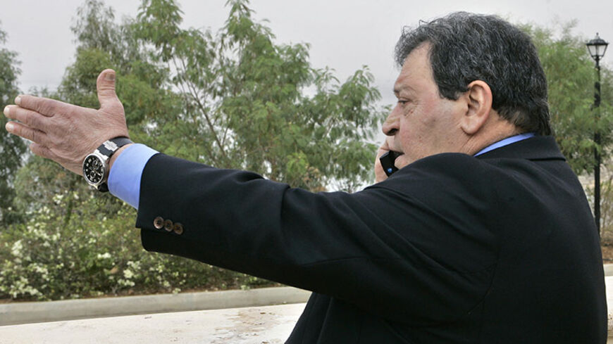 Israel's director-general of the Water Authority and Minister of National Infrastructure Binyamin Ben-Eliezer speaks on a mobile phone after the opening session of The Ministerial Conference on Water at the King Hussein Convention Centre at the Dead Sea Shore near Amman December 22, 2008. REUTERS/Muhammad Hamed (JORDAN) - RTR22SCR
