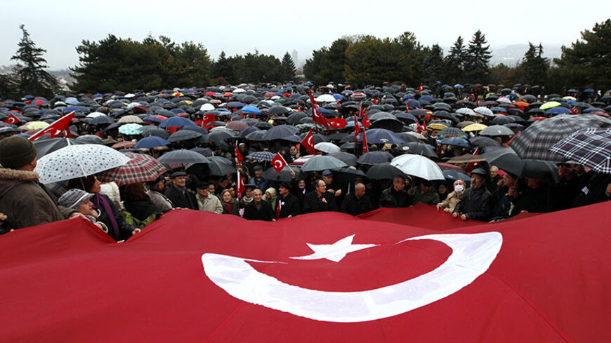 Wives and relatives of retired and active military officers charged in the so-called Sledgehammer trial march under a huge Turkish flag during a protest at Anitkabir, the mausoleum of Mustafa Kemal Ataturk, founder of secular Turkey, in Ankara February 19, 2011. Turkish police arrested nearly 200 retired and serving military officers, including former top commanders, who are accused of plotting a coup in 2003 to topple Prime Minister Tayyip Erdogan's government. The trial of alleged plotters of "Sledgehamme
