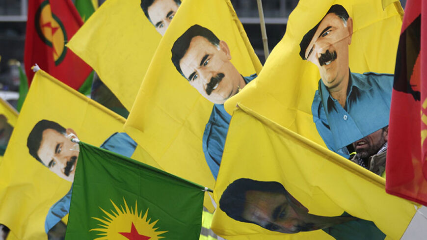 Kurdish demonstrators hold flags with portraits of jailed Kurdistan Workers Party (PKK) leader Abdullah Ocalan in front of the European Parliament in Strasbourg February 16, 2012, in support of Ocalan, who was captured on February 15, 1999, and is currently serving a life sentence in Turkey.  REUTERS/Vincent Kessler (FRANCE - Tags: POLITICS) - RTR2XXY4