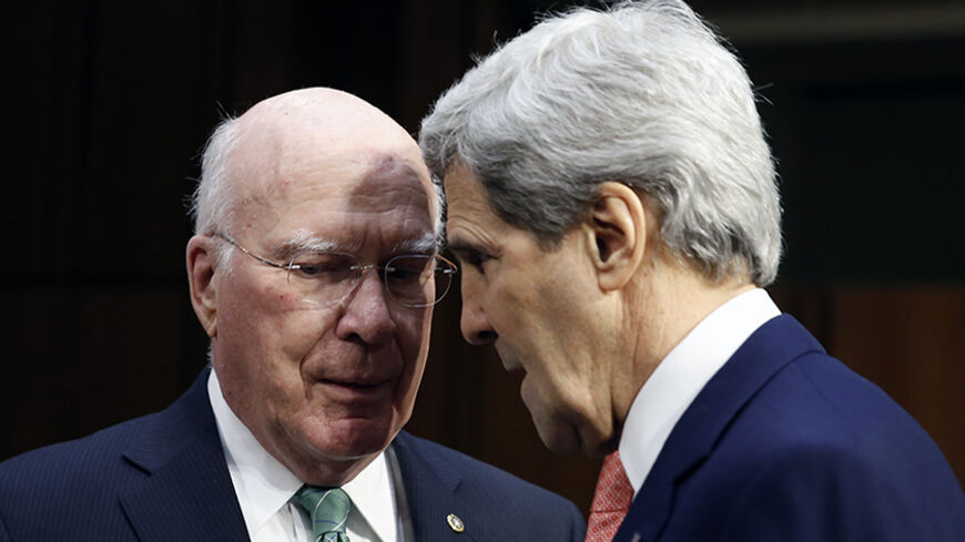 U.S. Secretary of State John Kerry (R) talks with Senator Pat Leahy (D-VT) as he arrives to testify at a Senate hearing to examine proposed budget estimates for fiscal year 2015 for the Department of State and Foreign Operations in Washington, March 13, 2014.  REUTERS/Kevin Lamarque  (UNITED STATES - Tags: POLITICS) - RTR3GYG9