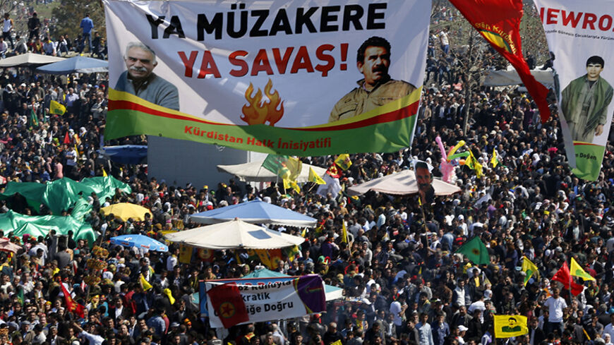A giant banner, which reads: "Negotiation or war" and shows different pictures of jailed Kurdish militant leader Abdullah Ocalan of the Kurdistan Workers Party (PKK), is displayed during a gathering celebrating Newroz, which marks the arrival of spring and the new year, in Diyarbakir March 21, 2014. Ocalan called on the Turkish government on Friday to create a legal framework for their peace talks, whose fate is looking increasingly uncertain a year after he called a ceasefire by his fighters. Tens of thous