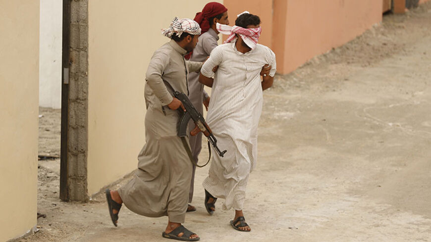 Members of Saudi special forces act a scene simulating kidnapping a man by terrorists during a training session in Darma, west of Riyadh March 26, 2014. REUTERS/Faisal Al Nasser (SAUDI ARABIA - Tags: MILITARY) - RTR3IPQA