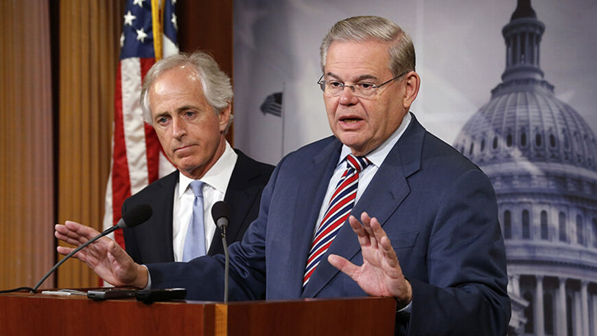 U.S. Senate Foreign Relations Committee Chairman Robert Menendez (D-NJ) (R) and ranking member Senator Bob Corker (R-TN) (L) hold a news conference after a Senate vote on an aid package for Ukraine at the U.S. Capitol in Washington March 27, 2014. REUTERS/Jonathan Ernst    (UNITED STATES - Tags: POLITICS) - RTR3IVO6